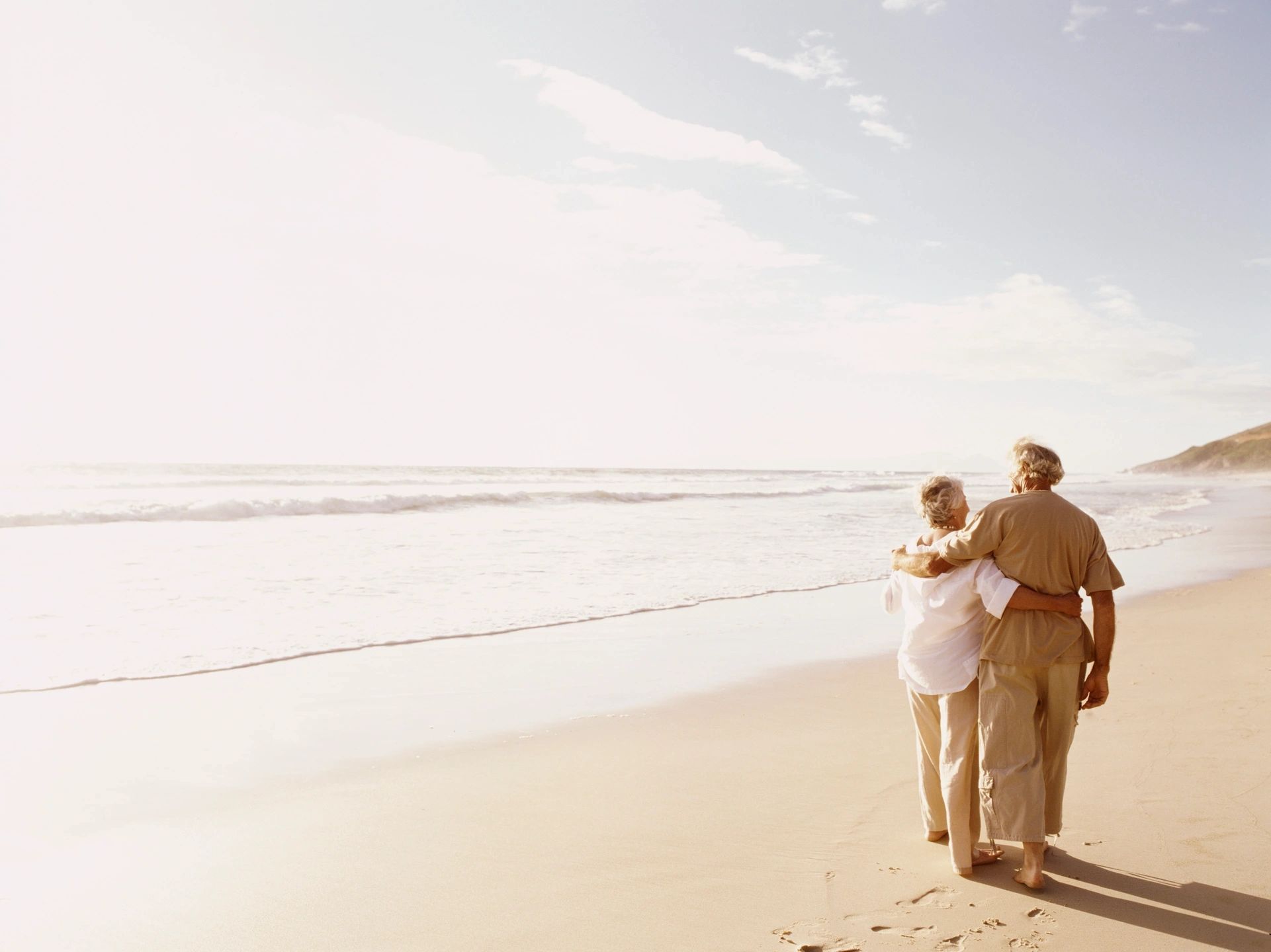 elderly couple by beach